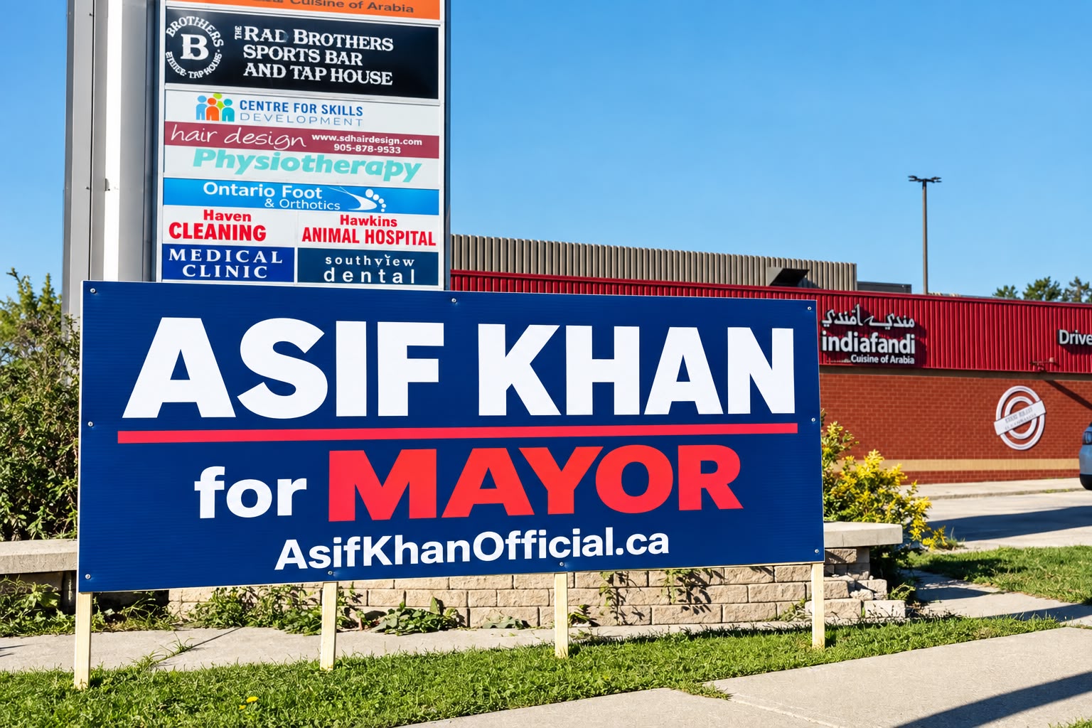 Asif Khan for Mayor campaign sign outside a Milton plaza