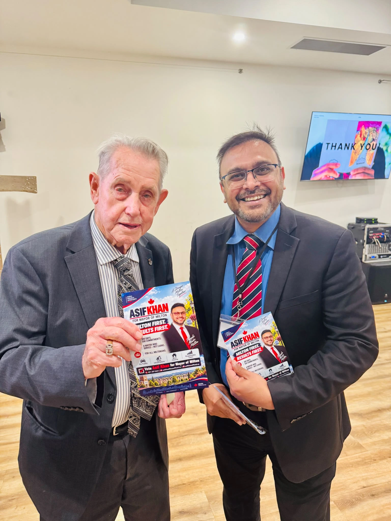 Asif Khan with incumbent Gordon Krantz holding campaign flyers